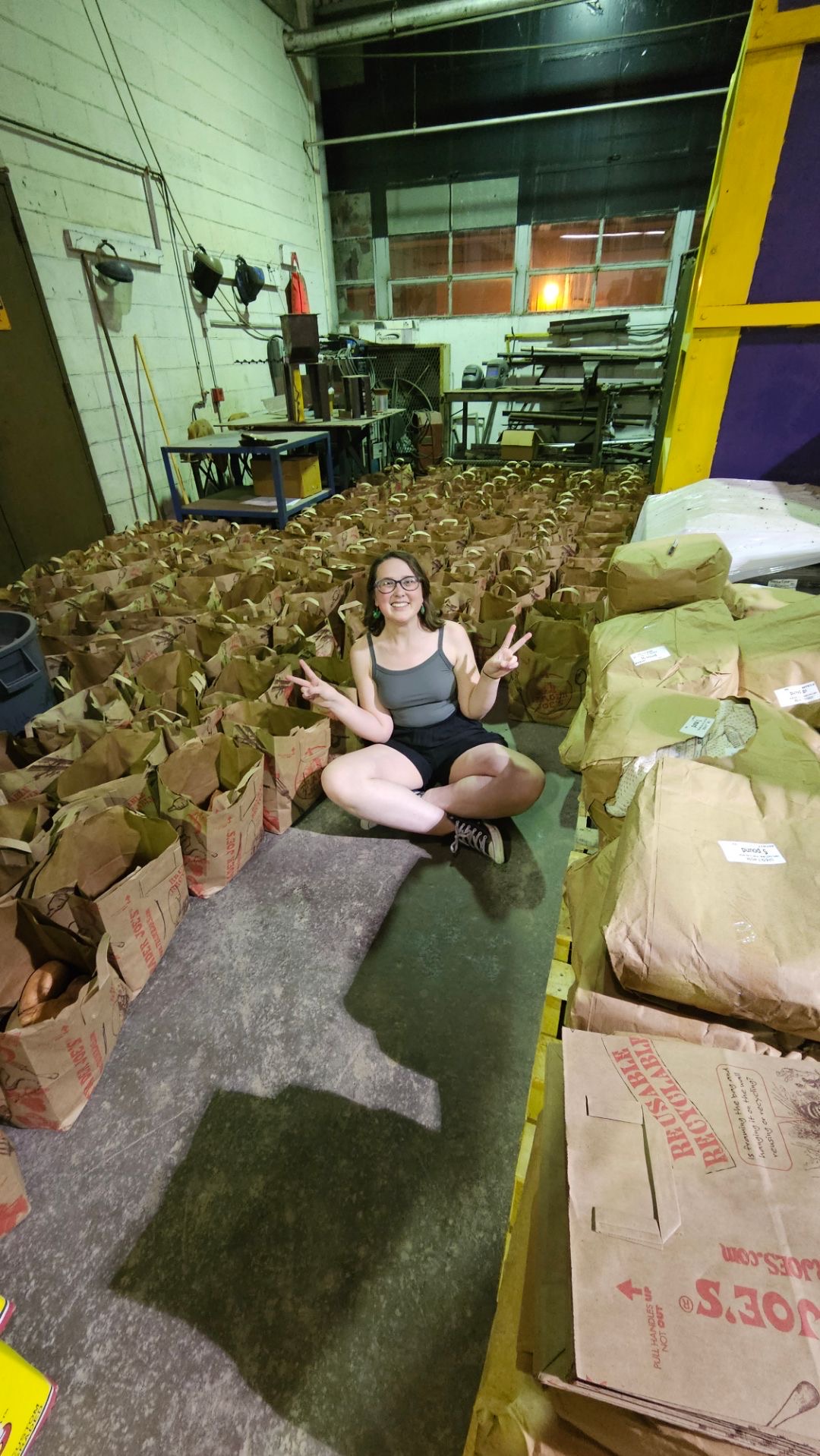 student with bags surrounding her