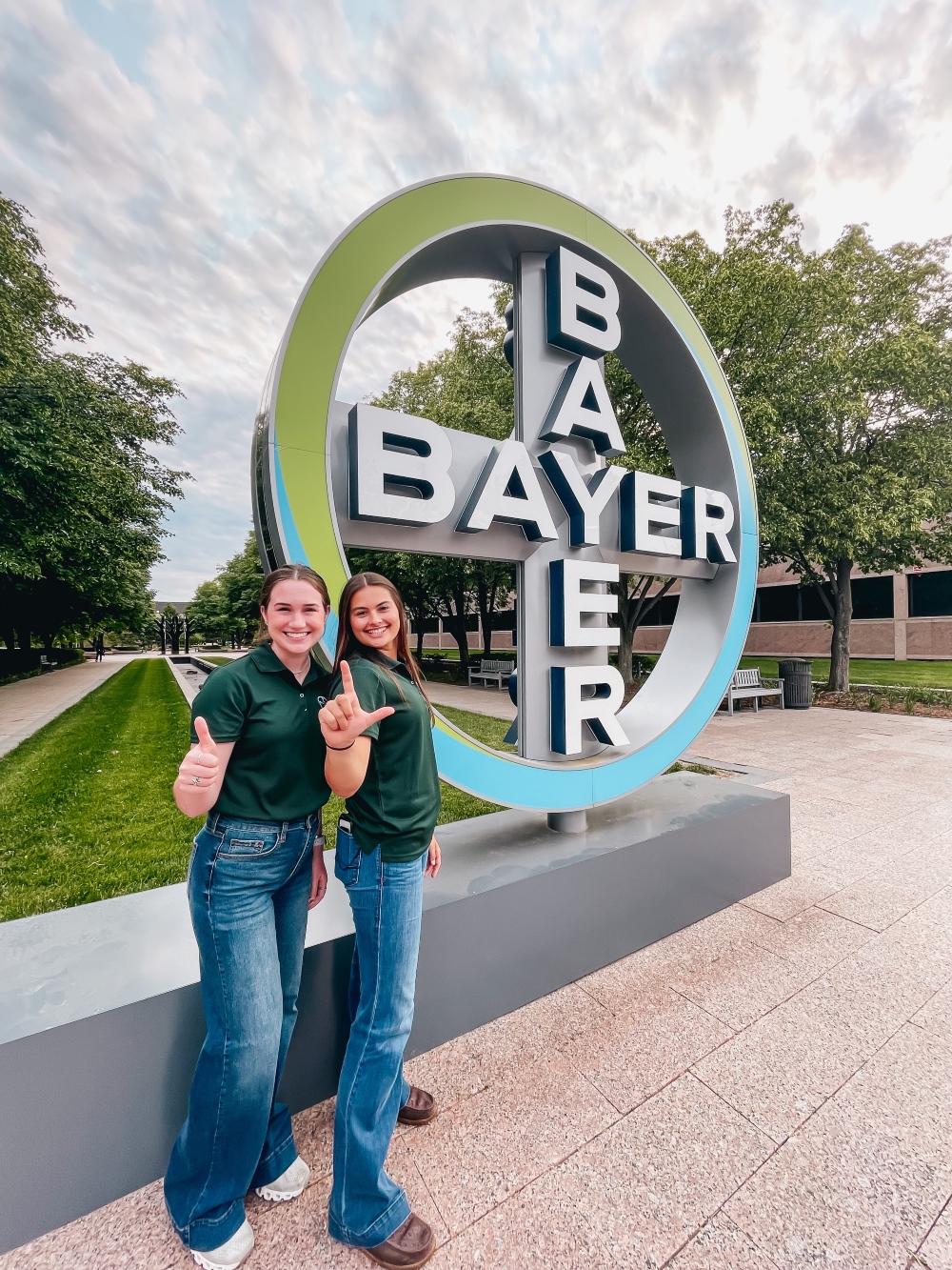 Students stand in front of Bayer logo
