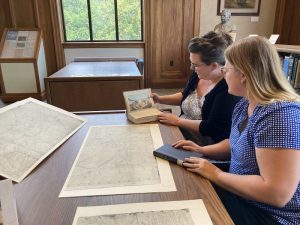 Librarians Hayley Johnson and Sarah Sims review a document