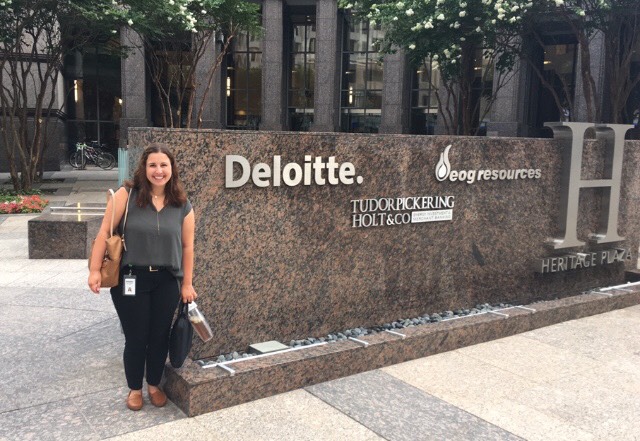 intern standing in front of Deloitte headquarters sign.