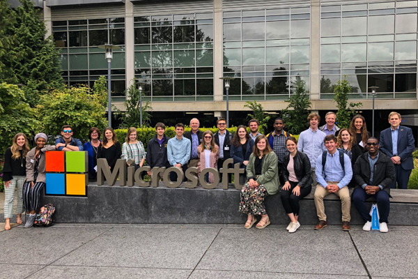 students in front of Microsoft headquarters sign