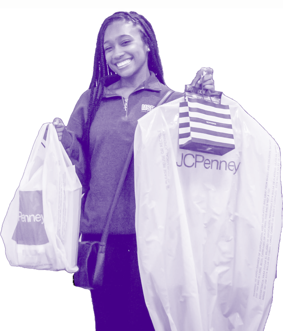 student holding up JCPenney clothes awarded by the suit up grant