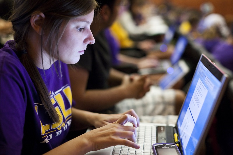 a woman works on a laptop