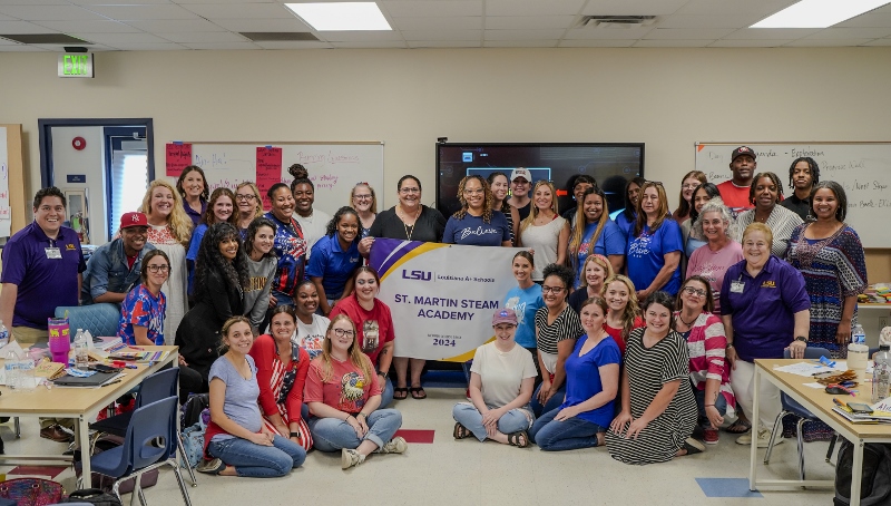 school staff holding louisiana aplus banner 