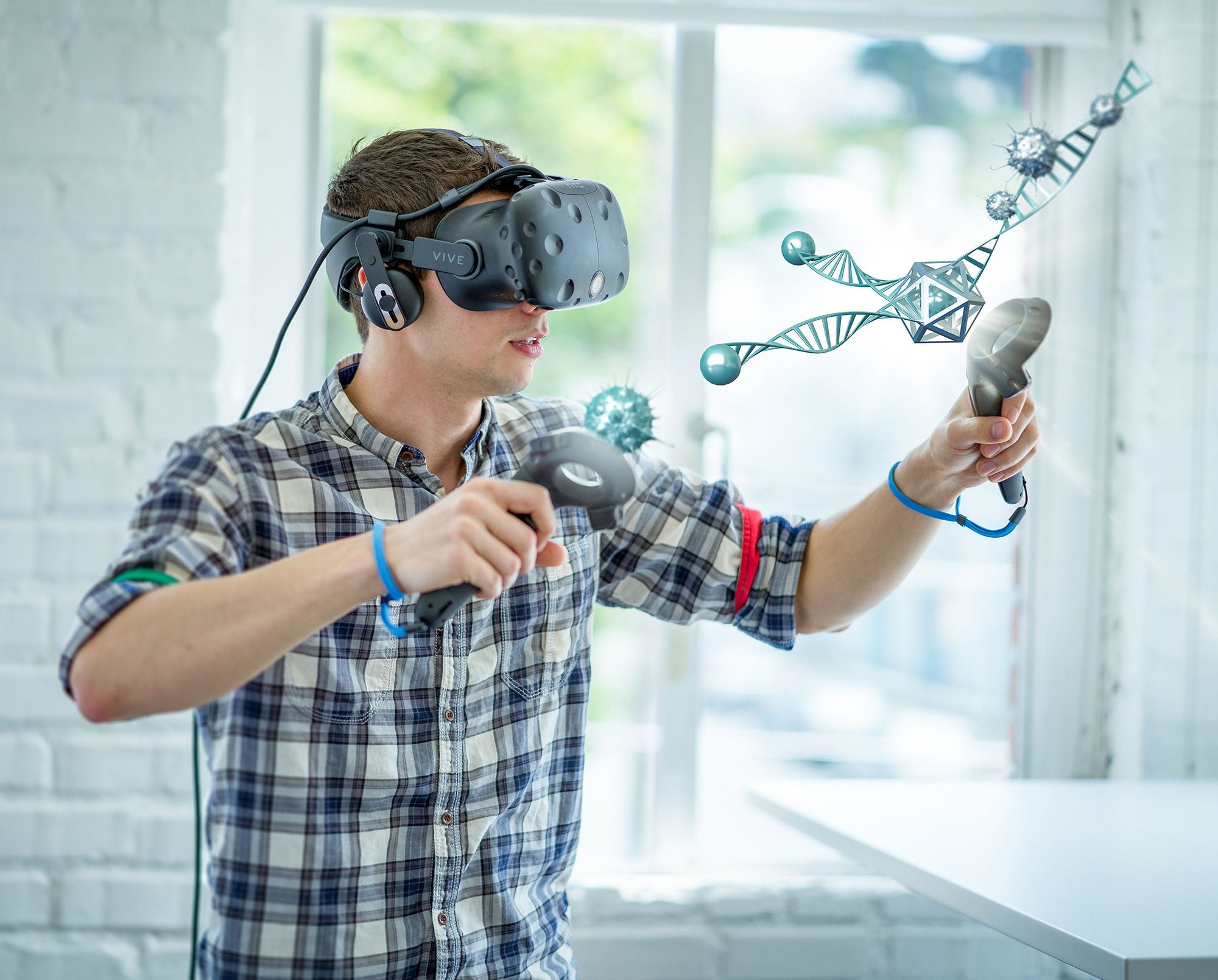 caucasian student wearing virtual reality headset working on a 3D model 