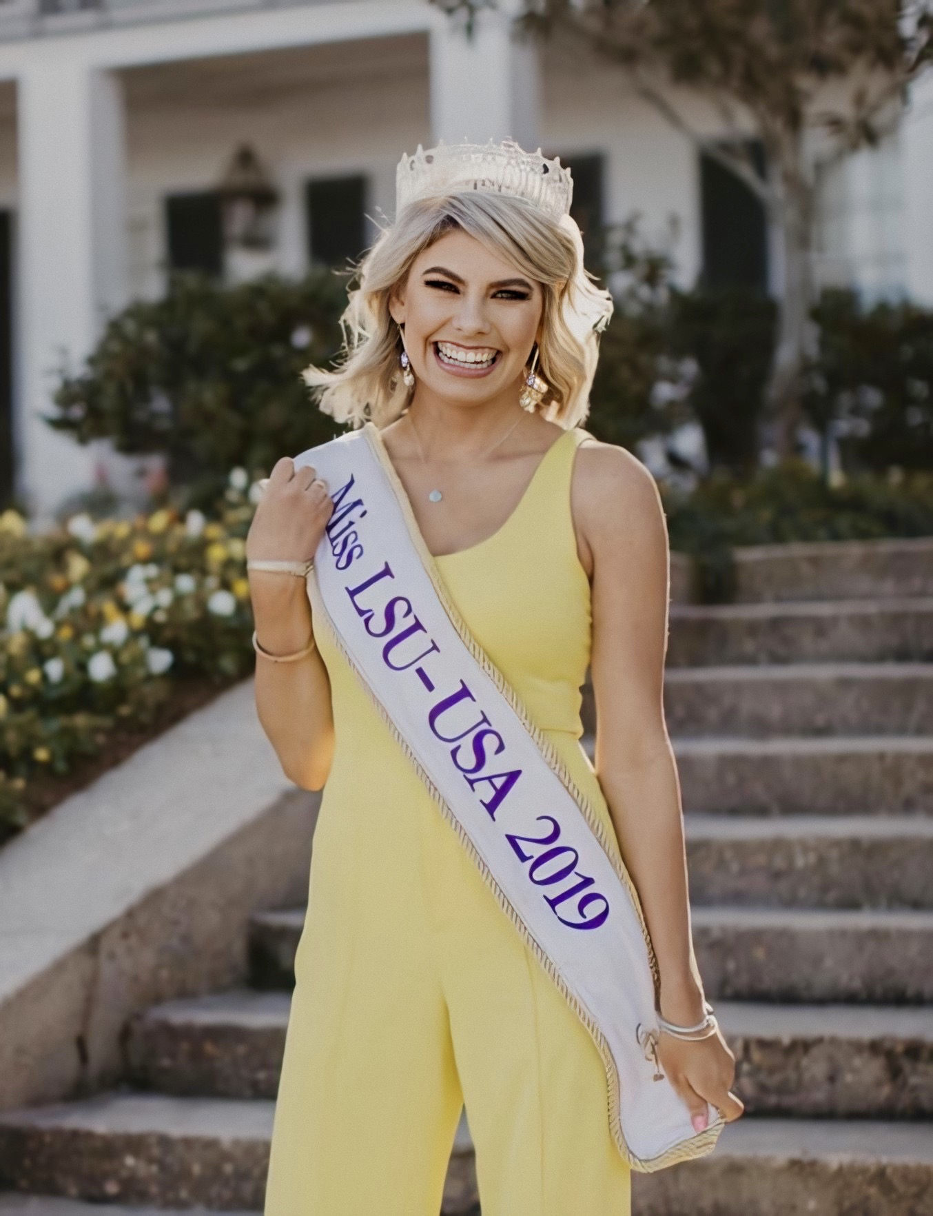 Keighley Kelley stands outside of her sorority house dressed in her crown and Miss LSU-USA 2019 sash.