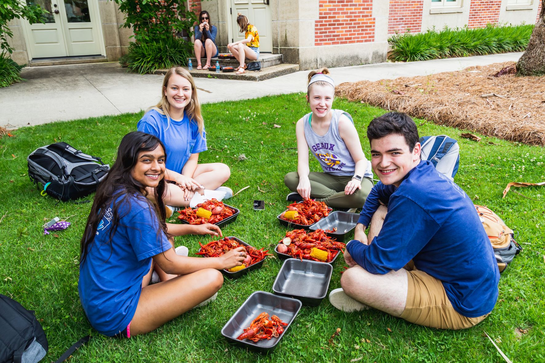 Honors students sitting in a circle at a Thesis Day crawfish boil