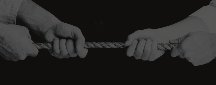 Hands pulling on either side of a rope