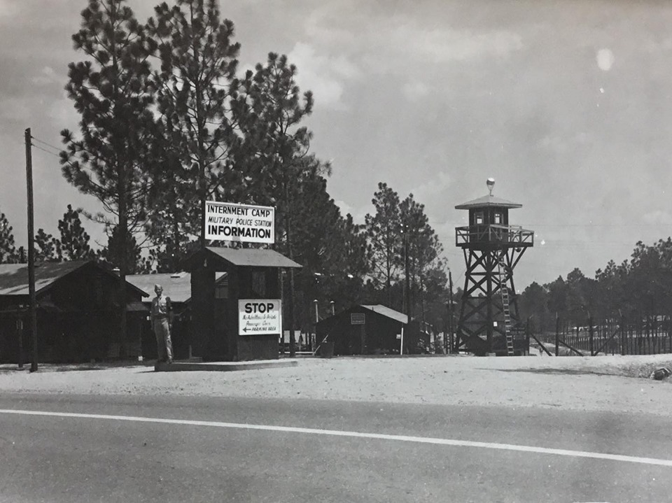 Exterior of a Japanese internment camp in Alexandria Louisiana featuring buildings and a watch tower