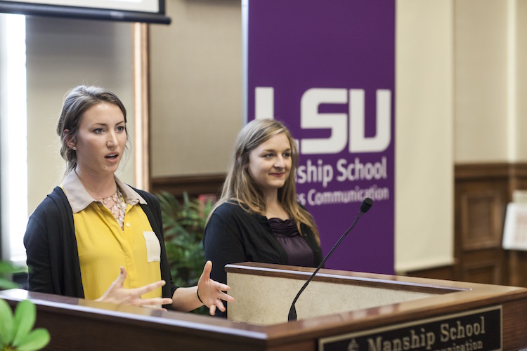 Students talking behind a podium
