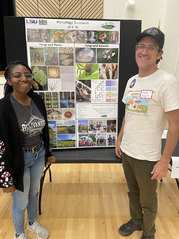 Student with mentor in front of research poster