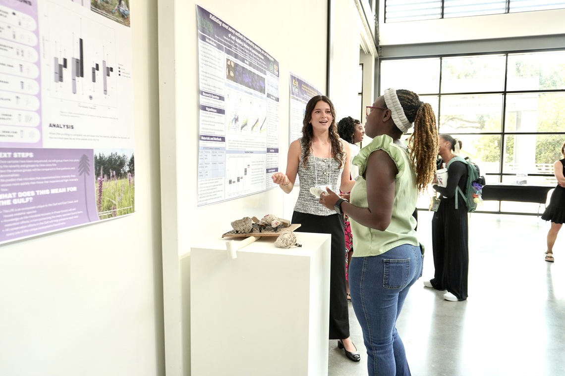 Student presenting a research project at an event.