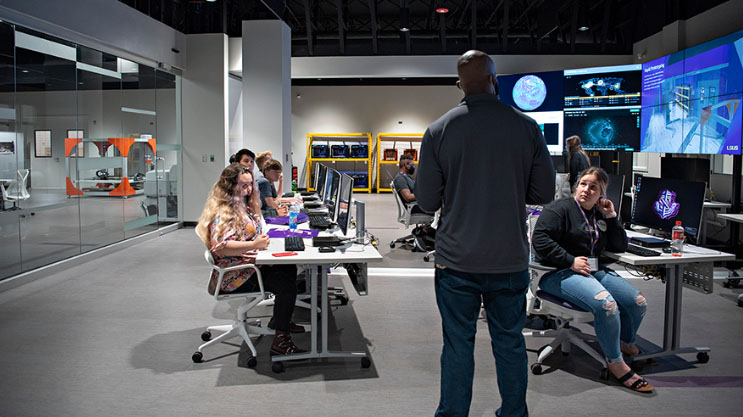 students with instructor in cybersecurity lab