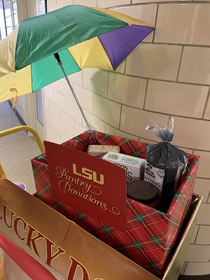 LSU Press Lucky Dogs Cart filled with Food Items to Donate