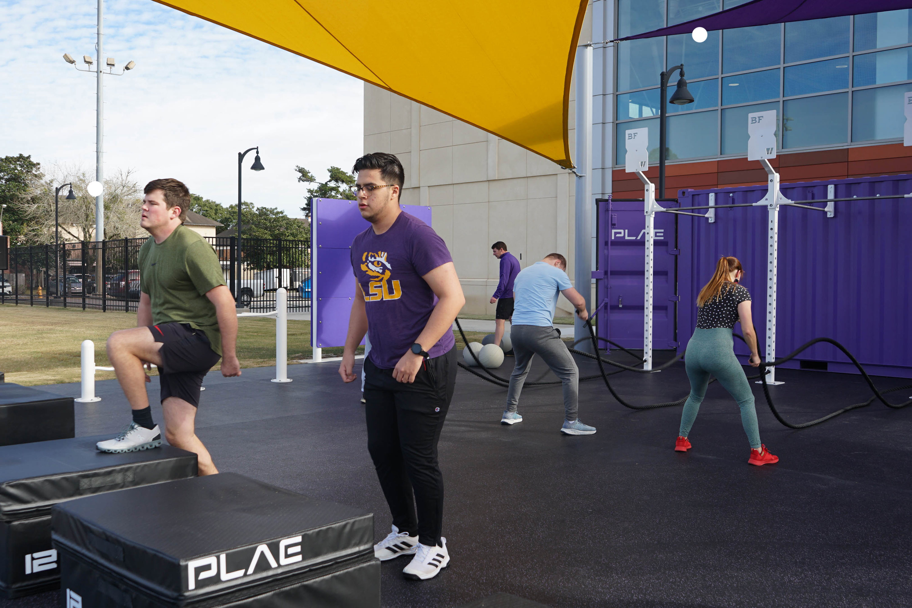 patrons getting a workout in in outdoor fitness area